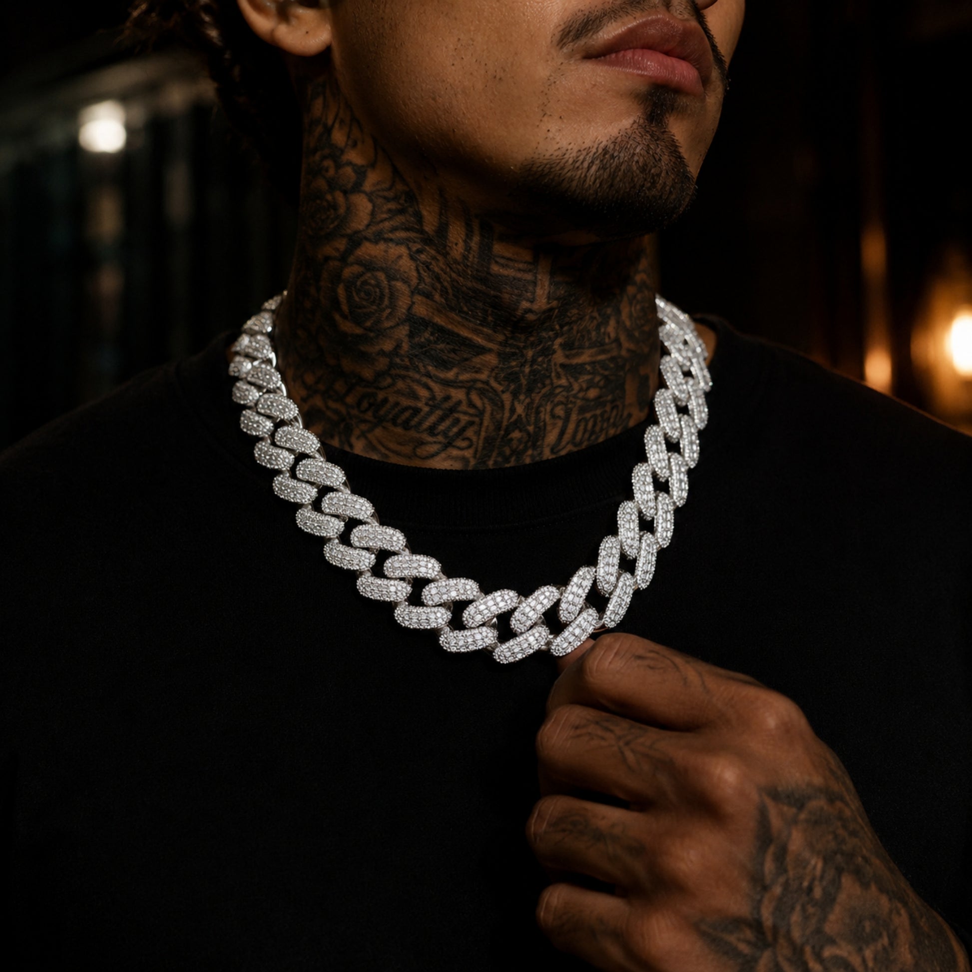 Male model wearing a 28mm iced out Cuban link chain necklace
