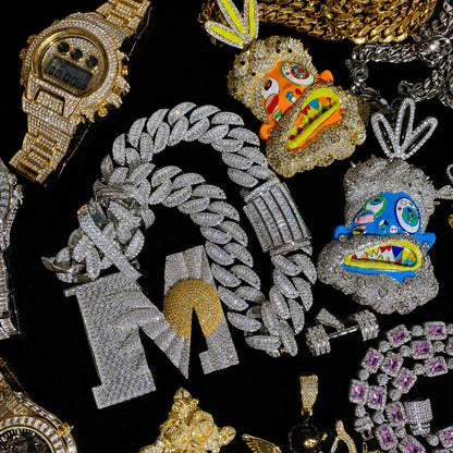 BEGIN AGAIN Letter M Sunrise pendant paired with Arc iced Cuban chain options.
