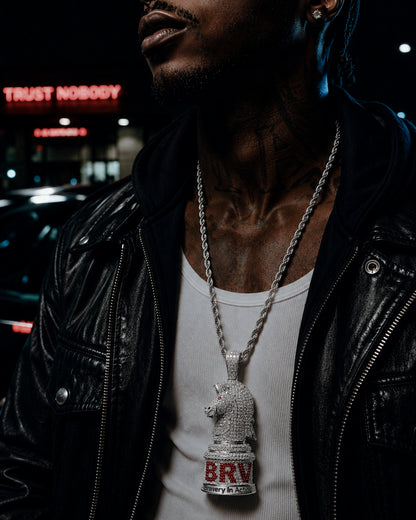 Male model wearing the ICEDIAMOND white gold BRAVERY knight pendant necklace with a streetwear outfit.
