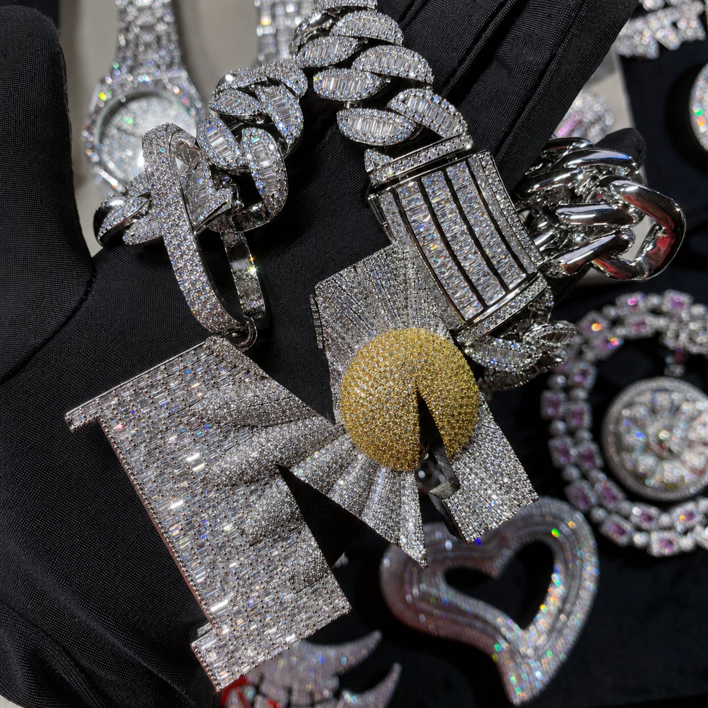 Close-up of the BEGIN AGAIN Letter M Sunrise pendant showing hand-set 5A cubic zirconia and premium craftsmanship.
