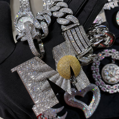Close-up of the BEGIN AGAIN Letter M Sunrise pendant showing hand-set 5A cubic zirconia and premium craftsmanship.
