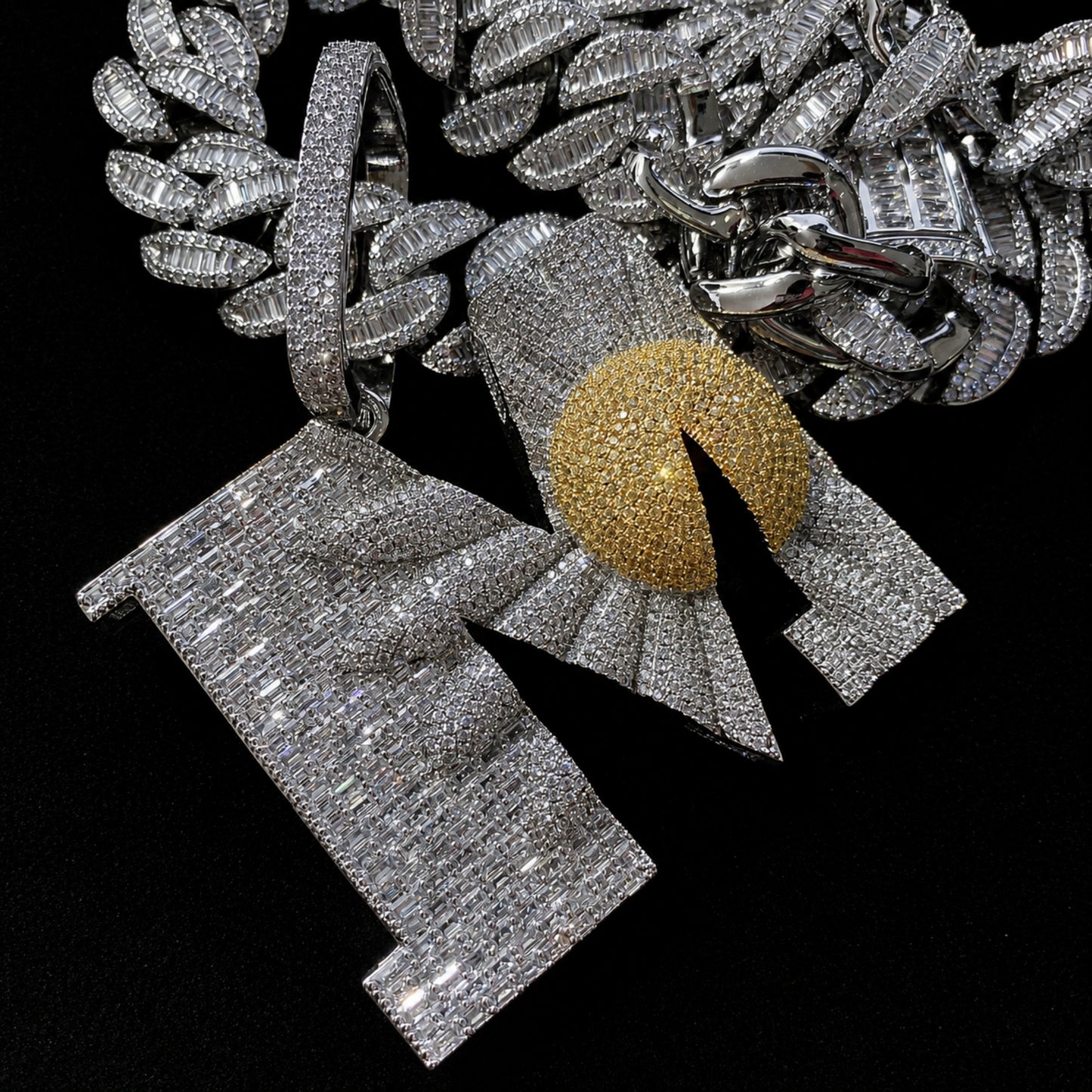 Detailed view of the ICEDIAMOND BEGIN AGAIN pendant featuring the sunrise inside the letter M.
