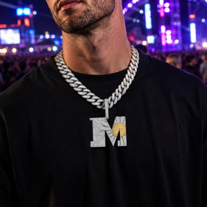 Male model wearing the ICEDIAMOND BEGIN AGAIN Letter M Sunrise pendant necklace with a luxury streetwear outfit.
