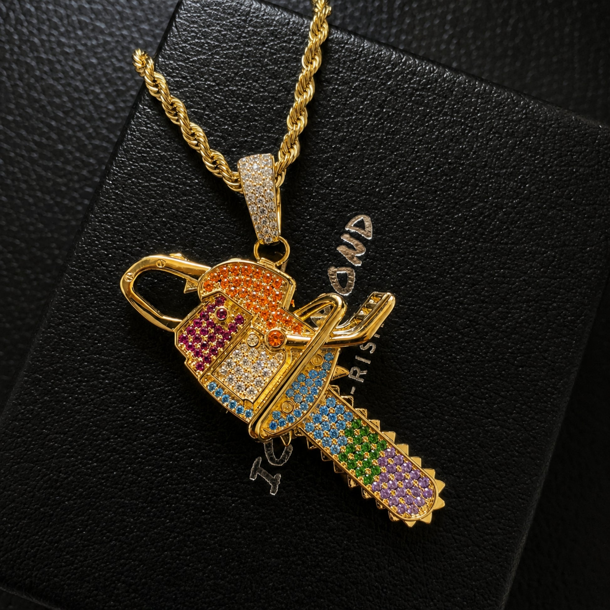 Close-up of colorful hand-set cubic zirconia on the chainsaw pendant
