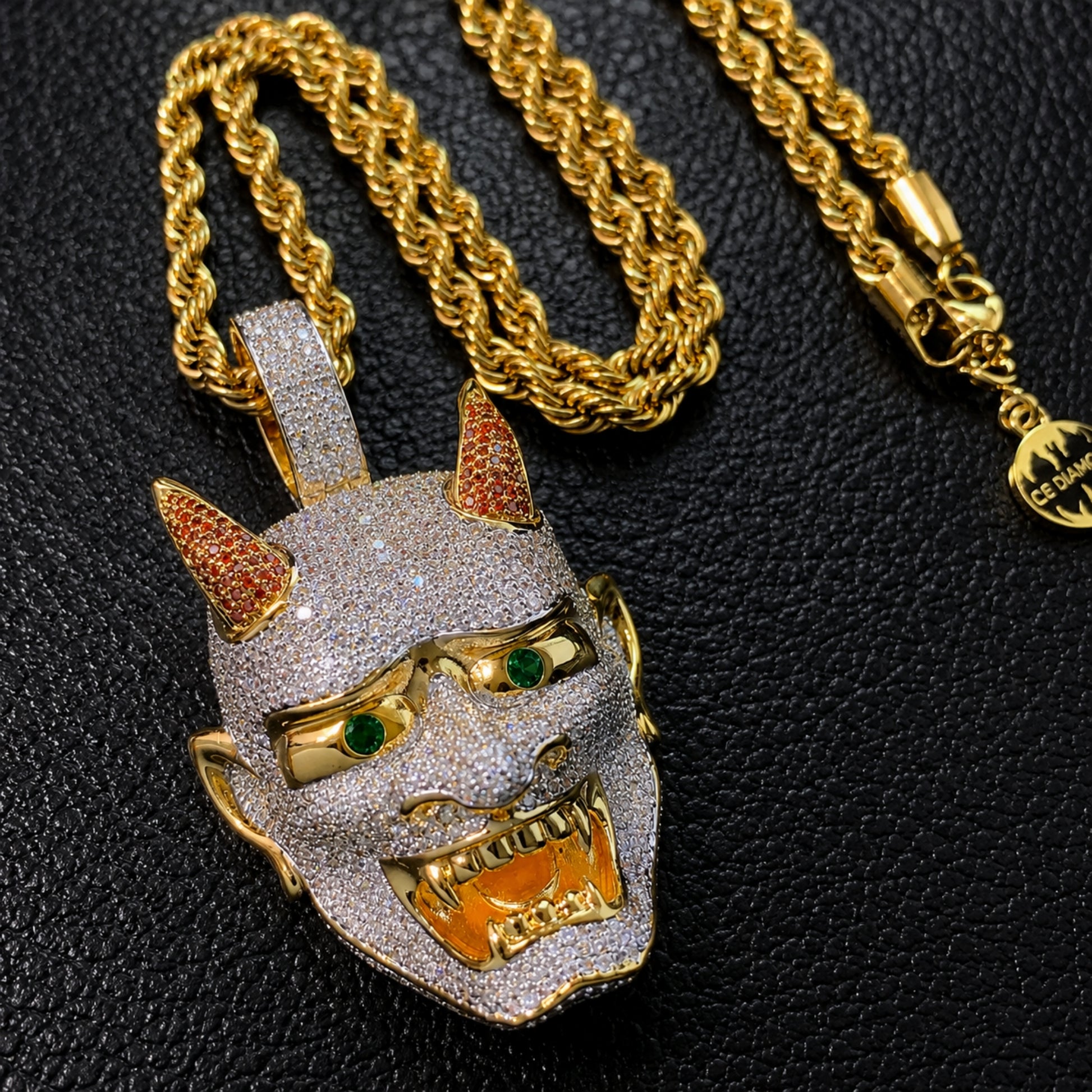 Close-up of the LET LIGHT IN Oni mask pendant showing hand-set 5A cubic zirconia and detailed craftsmanship.
