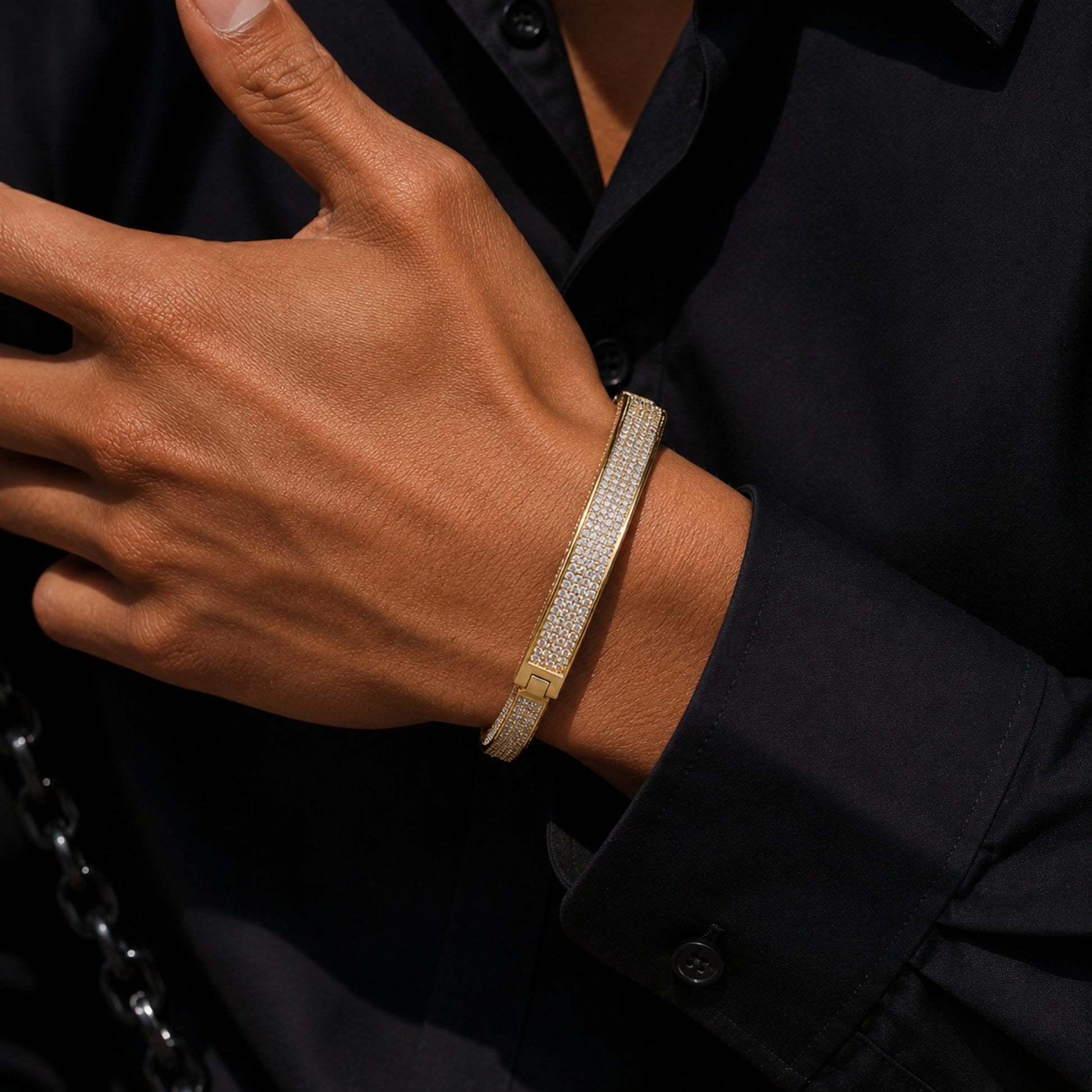 ICEDIAMOND LIVE UNBOUND iced out lock-inspired bracelet worn on wrist showing adjustable cuff fit.
