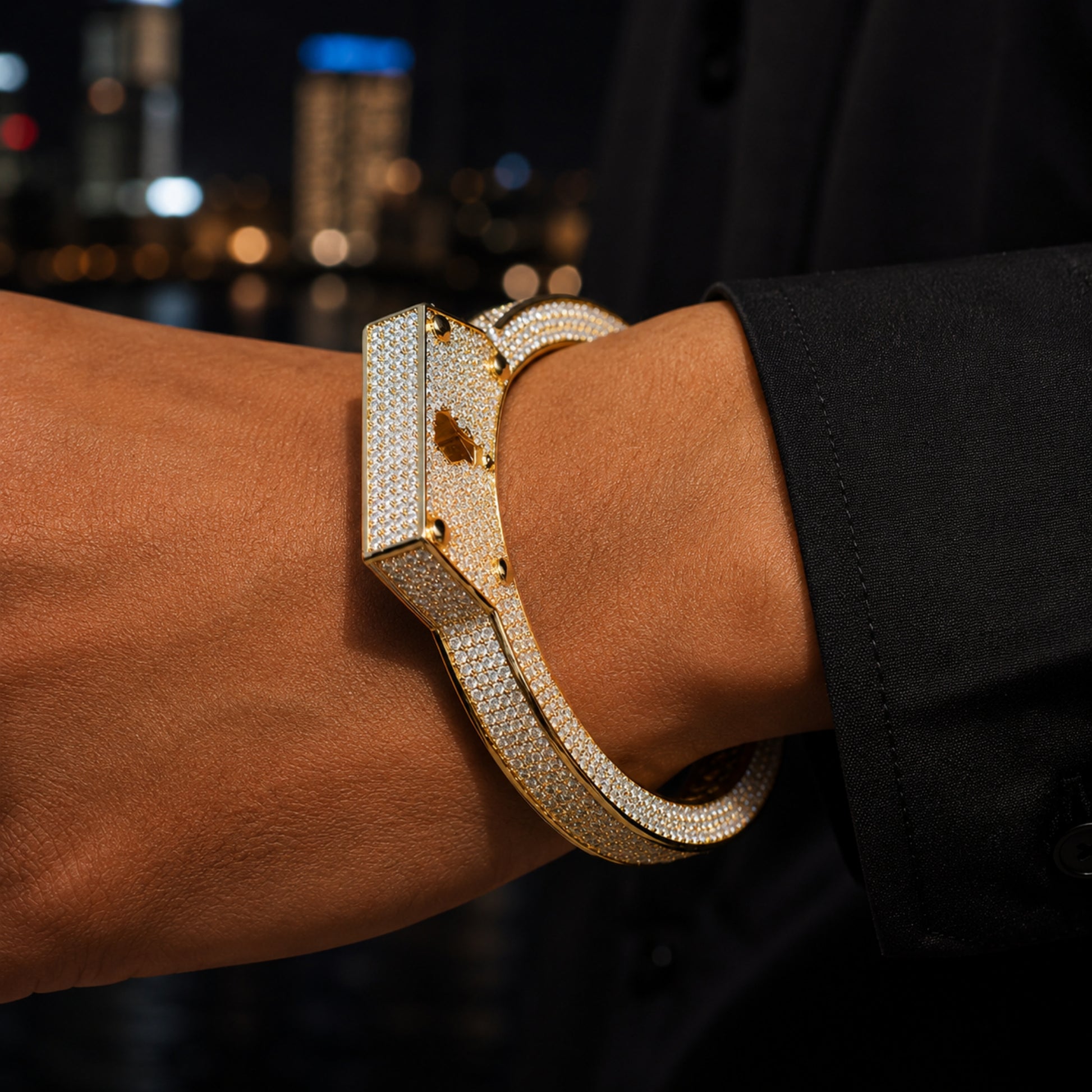 ICEDIAMOND LIVE UNBOUND iced out lock-inspired bracelet worn on wrist showing adjustable cuff fit.
