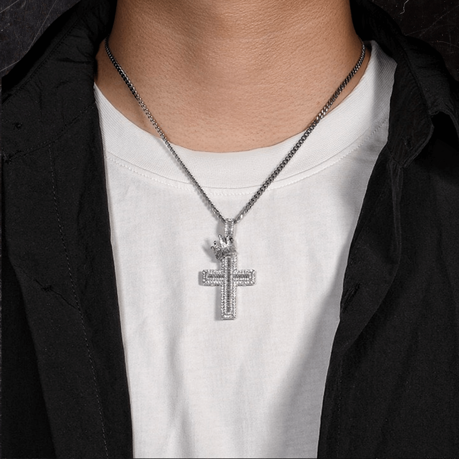 Male model wearing ICEDIAMOND STAND TALL crown cross pendant necklace

