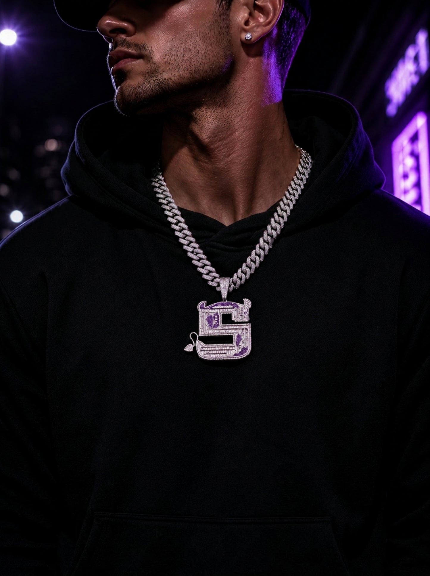 Male model wearing the ICEDIAMOND OWN YOUR EDGE Letter S pendant necklace with a streetwear outfit.
