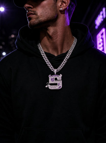 Male model wearing the ICEDIAMOND OWN YOUR EDGE Letter S pendant necklace with a streetwear outfit.

