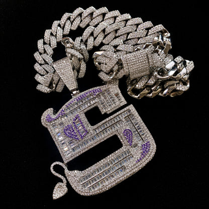 OWN YOUR EDGE Letter S pendant paired with 14 mm iced out 14k gold finished edge Cuban chain options.
