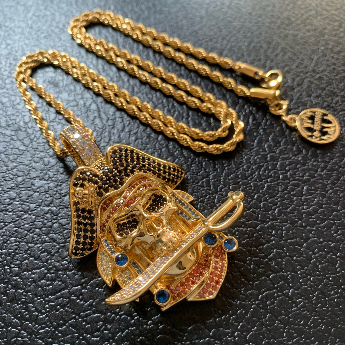 Close-up of pirate skull and curved sword pendant details