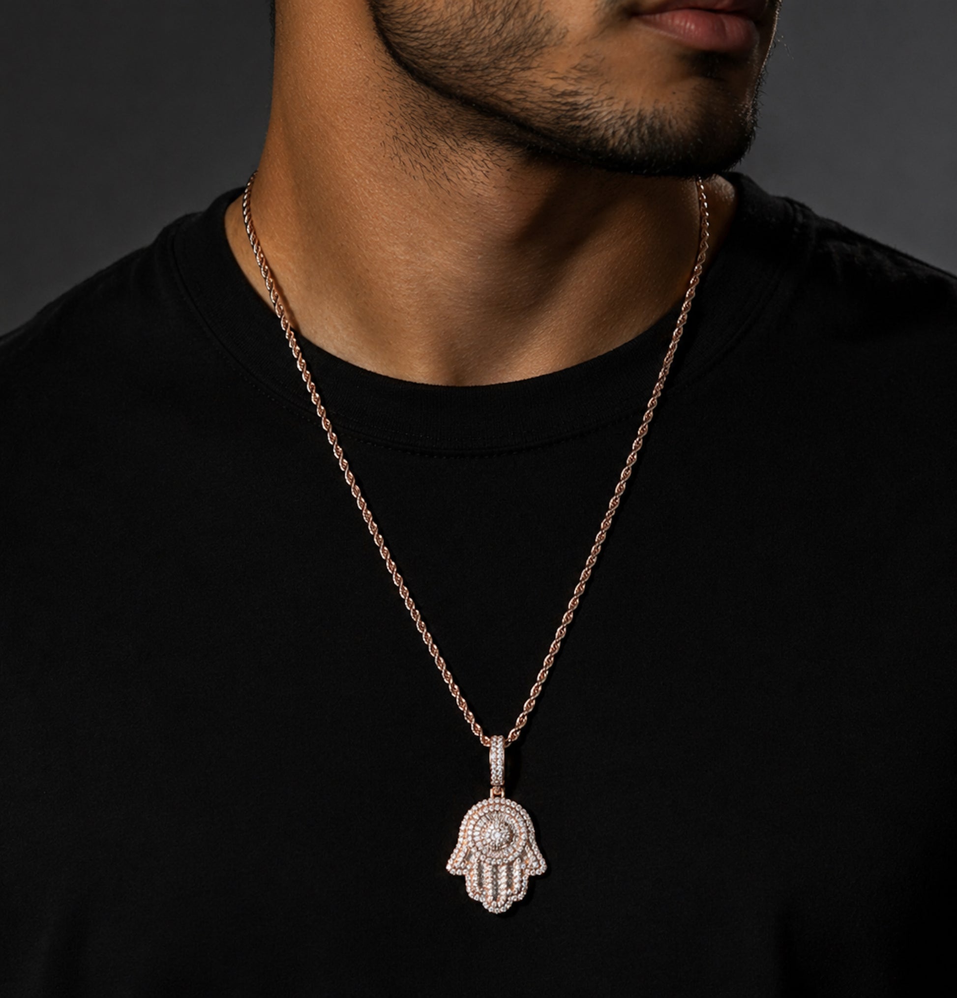 Male model wearing ICEDIAMOND rose gold SAFE HARBOR Hamsa Hand pendant necklace
