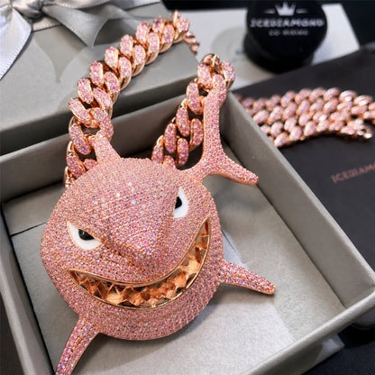 Close-up of the smiling shark pendant with glossy enamel eyes
