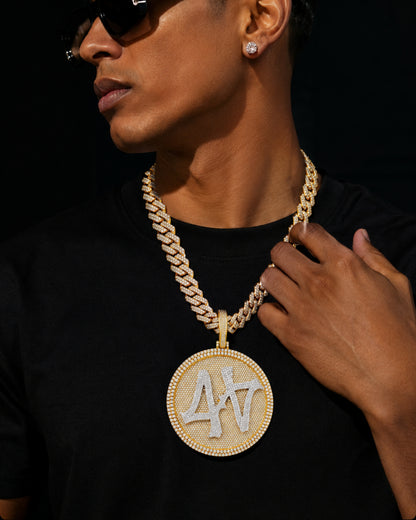 Model wearing the 14k gold finished ICEDIAMOND TURN THE GAME oversized spinner pendant necklace with 14mm iced out cuban chain.
