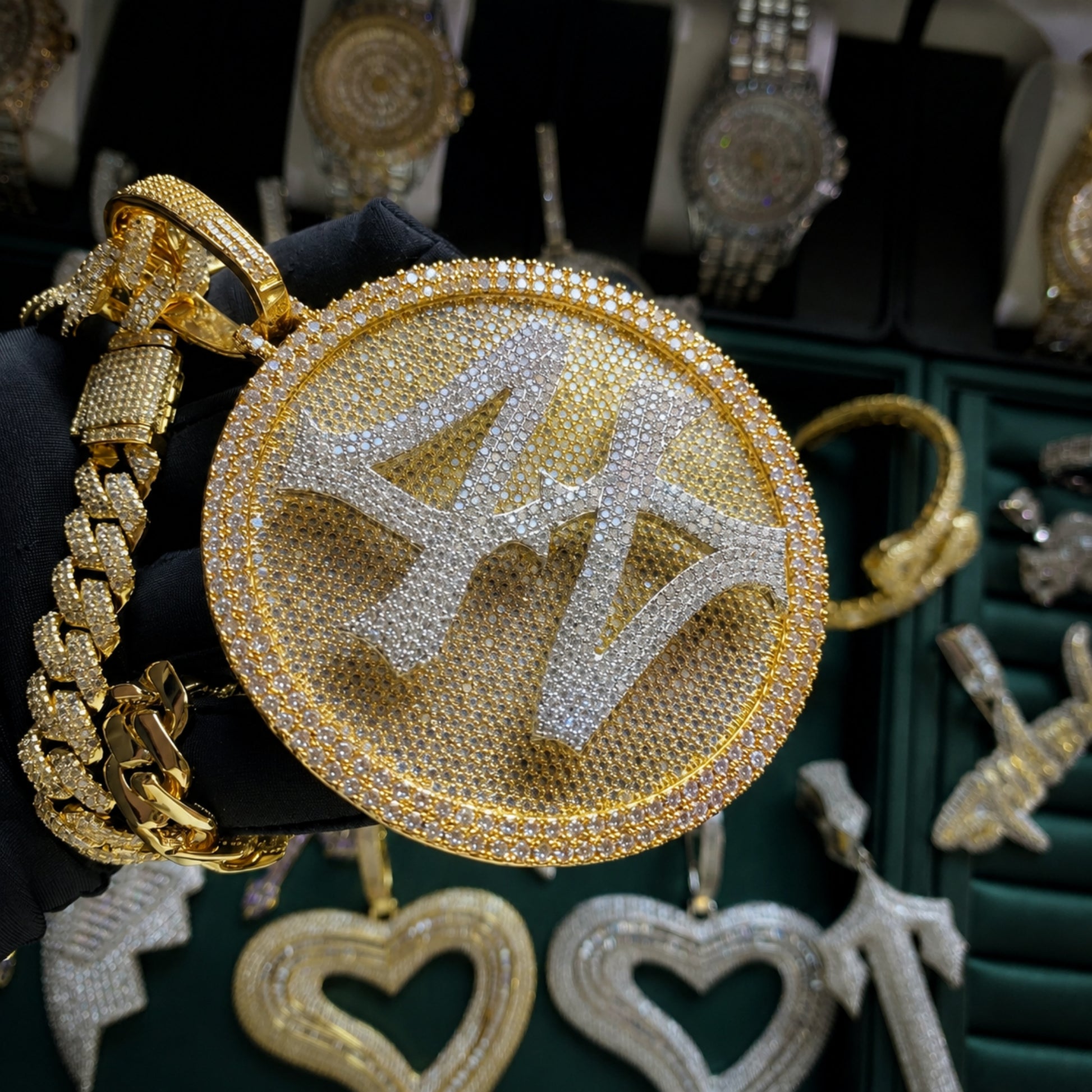 Angled view of the TURN THE GAME rotating spinner pendant showcasing micro pavé stones and polished gold finish.
