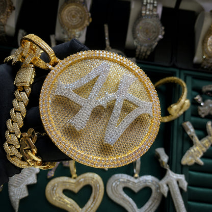 Angled view of the TURN THE GAME rotating spinner pendant showcasing micro pavé stones and polished gold finish.
