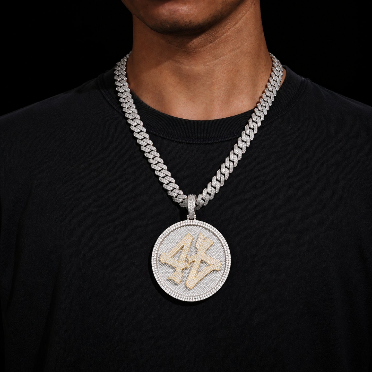 Model wearing the ICEDIAMOND TURN THE GAME oversized spinner pendant necklace with 14mm iced out cuban chain.
