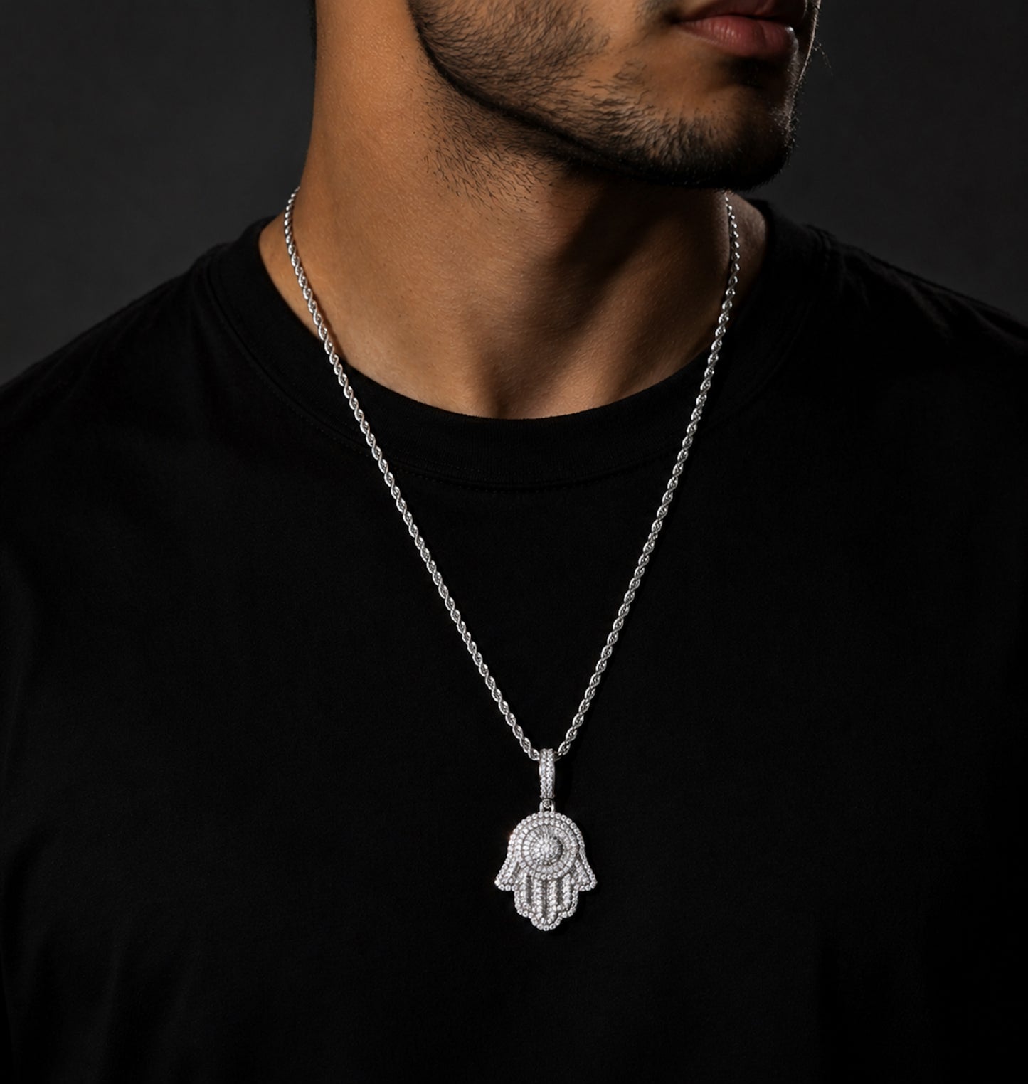 Male model wearing ICEDIAMOND white gold SAFE HARBOR Hamsa Hand pendant necklace
