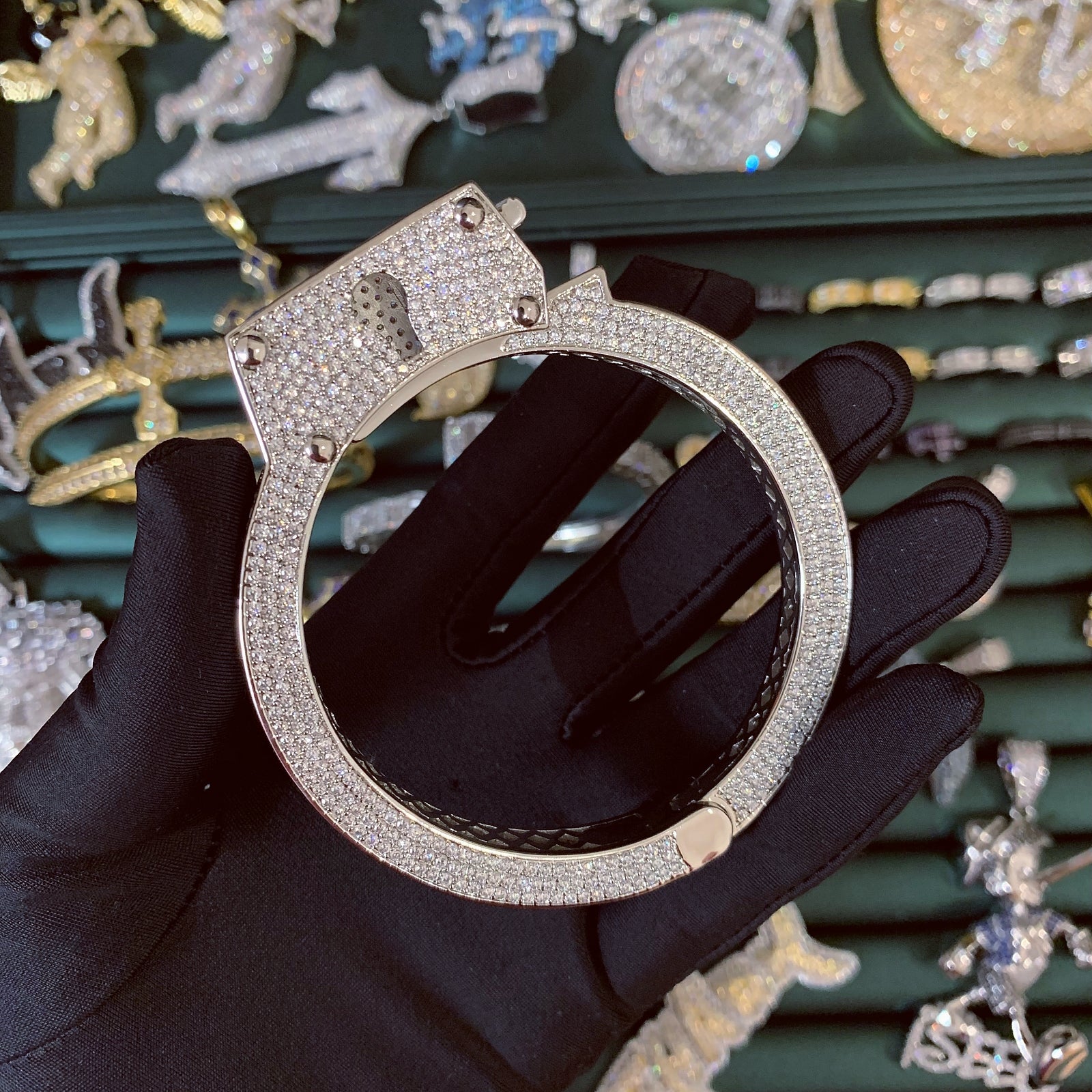 ICEDIAMOND LIVE UNBOUND lock-inspired iced out bangle bracelet in 14K gold plating with hand-set 5A cubic zirconia.
